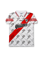 Front view of River Plate 1996–97 home shirt in white with red diagonal sash, Quilmes sponsor, adidas logo, club crest, and all-over graphic pattern.