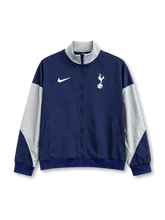Tottenham Hotspur Nike track jacket in navy with white raglan sleeve panels, white stand collar, Nike Swoosh at left chest, embroidered cockerel crest at right chest