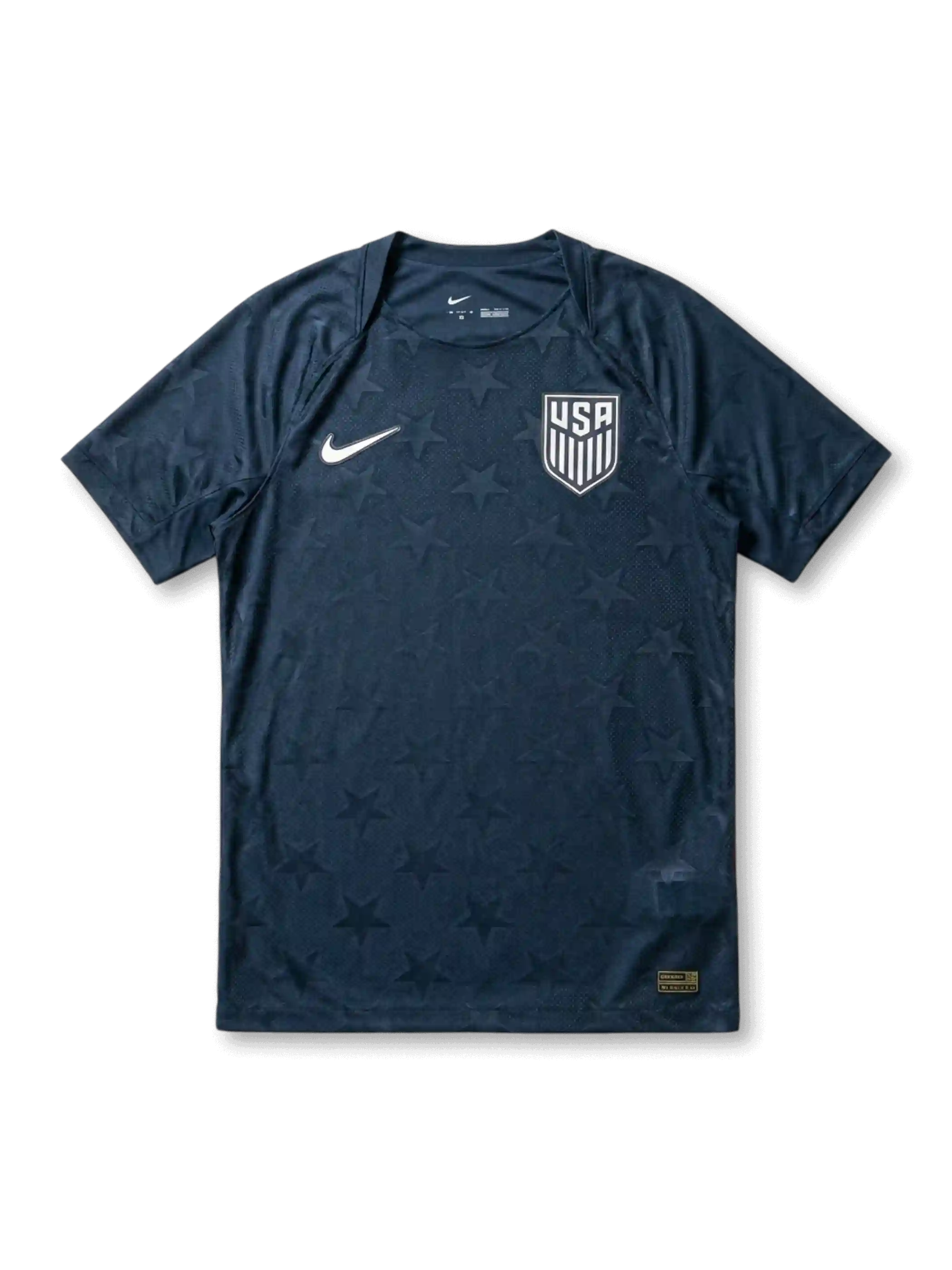 USA national team Nike 2026/27 Authentic (Player Issue) away jersey in navy with tonal allover star jacquard texture, white Swoosh at left chest, white USA shield crest at right chest, plain navy crew collar and cuffs, gold authentication label at lower right hem