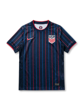 USA national team Nike 2025/26 World Cup away jersey in navy with alternating red and blue vertical pinstripes, red crew collar with white inner trim, red Swoosh at left chest, USA shield crest in white at right chest, red sleeve cuff bands
