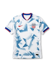 USA national team Nike 2025/26 World Cup home jersey in white with full-surface angular geometric grey shatter-camo print, tricolor V-neck collar in red and blue, red Swoosh at left chest, USA shield crest at right chest, red and blue sleeve cuff bands