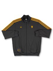 2025/26 Manchester United adidas Originals Icon short-sleeve track top in black with amber gold Three Stripes, gold standalone red devil crest at right chest, gold Trefoil at left chest, twin zip side pockets, and co-branded woven label at hem