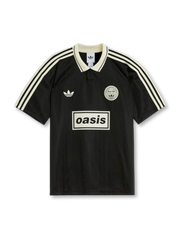 Front view of Oasis Live ’25 black collared shirt with off-white stripes, trefoil chest logo, circular crest, and boxed oasis graphic.