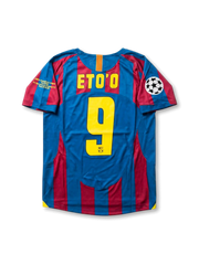 Front view of Barcelona 2005-06 Paris Final home shirt with blaugrana stripes, club crest, yellow detailing, Champions League patch, and final sleeve embroidery.