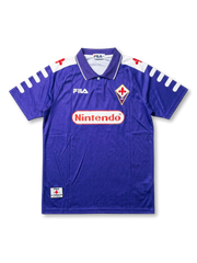 Front view of Fiorentina 1998-99 home shirt with purple body, Nintendo sponsor, Fiorentina crest, Fila logo, and white shoulder detailing.