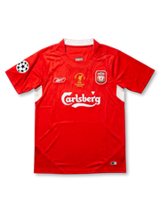 Front view of Liverpool 2005 Champions League Final home shirt with red body, Carlsberg sponsor, club crest, Reebok logo, and UEFA sleeve patch.