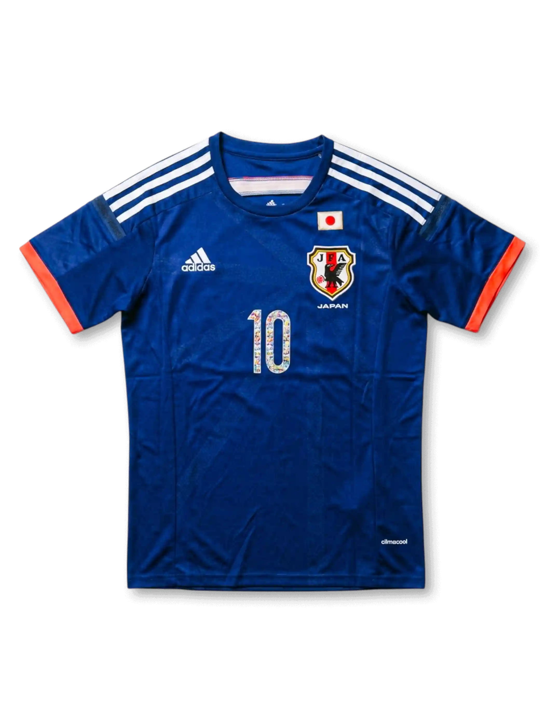 Front view of Japan Captain Tsubasa special edition shirt with blue body, JFA crest, Japan flag detail, orange sleeve trim, and illustrated #10 front number.