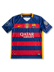Front view of Barcelona 2015-16 Champions League home shirt with red and blue horizontal stripes, Qatar Airways sponsor, club crest, FIFA badge, and European sleeve patches.