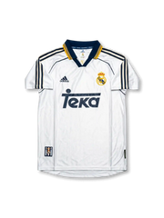 Front view of Real Madrid 1998-00 home shirt with white base, Teka sponsor, navy-and-gold collar trim, adidas logo, and club crest.