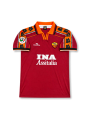 Front view of AS Roma 1998-99 home shirt with red body, orange collar, wolf-pattern shoulder panels, INA Assitalia sponsor, and club crest.