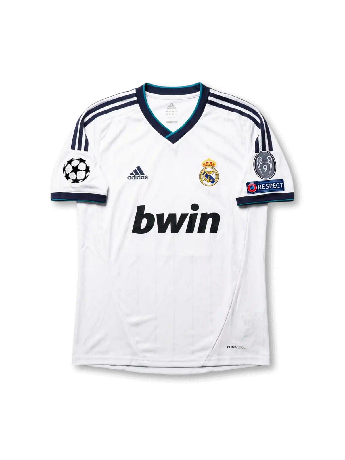 Front view of Real Madrid 2012-13 home jersey with white base, navy shoulder stripes, teal trim, club crest, sponsor, and Champions League sleeve patches.