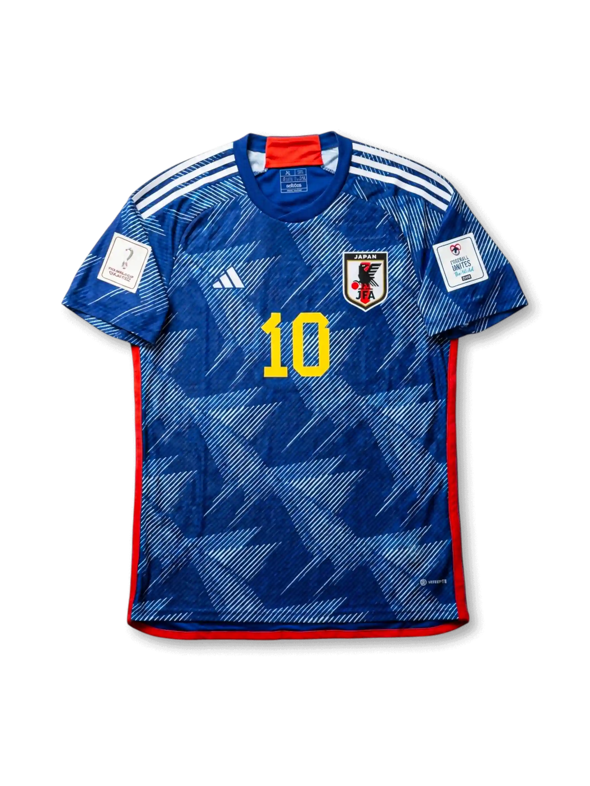 Front view of Japan 2022 World Cup home shirt with blue origami-inspired pattern, Japan crest, yellow #10 print, red trim, and Qatar 2022 sleeve patch.