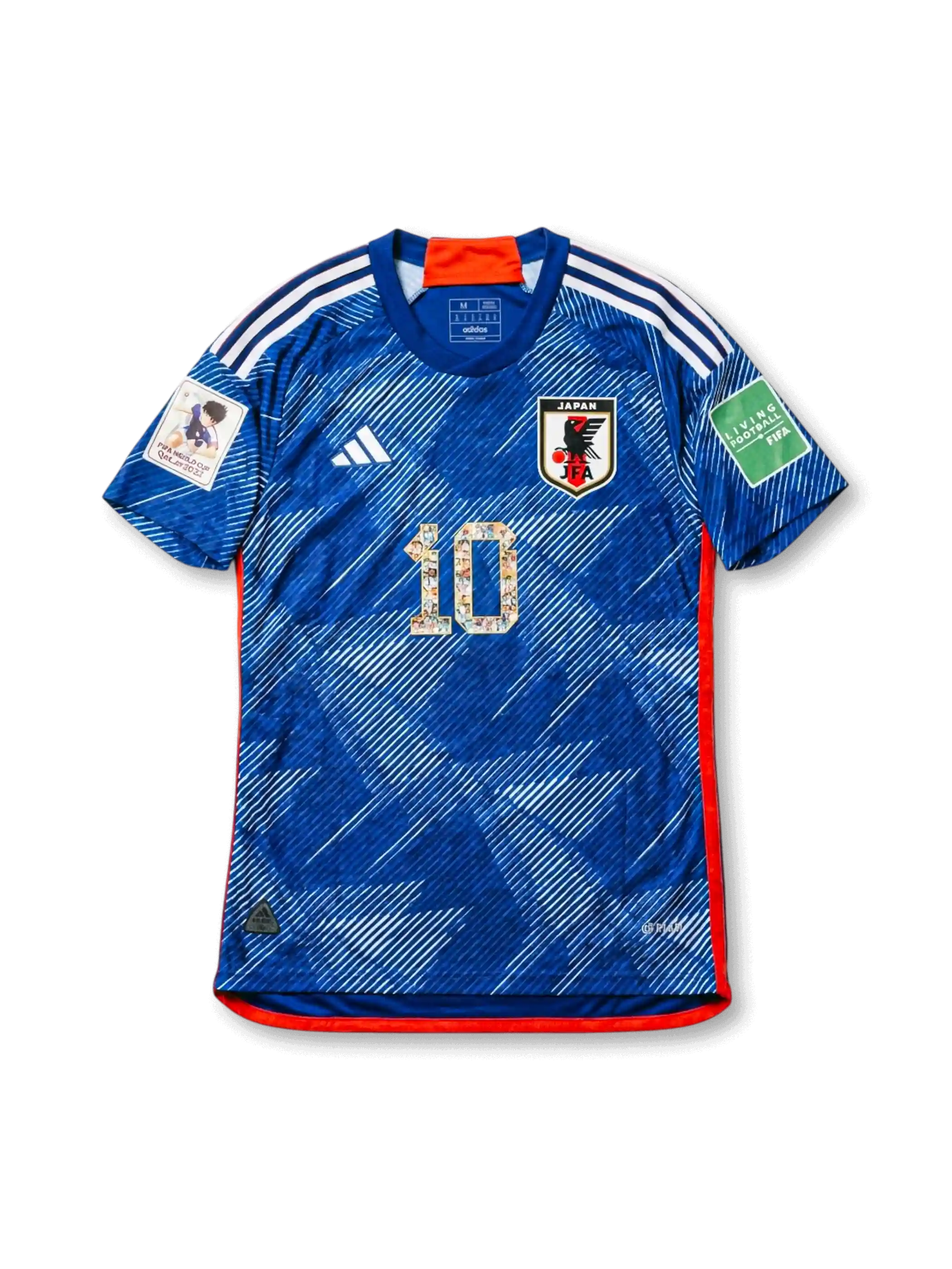 Front view of Japan 2022 Captain Tsubasa collaboration shirt with blue angular graphic design, Japan crest, illustrated #10 detail, red trim, and sleeve patches.