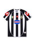 Front view of Juventus 2002-03 home jersey with black-and-white stripes, Tamoil sponsor, Scudetto shield, two-star crest, and red sleeve panels.