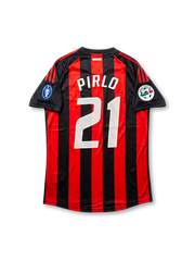Back view of AC Milan Pirlo #21 legacy edition shirt with red and black stripes, white player printing, black sleeve panels, and sleeve patch detailing.