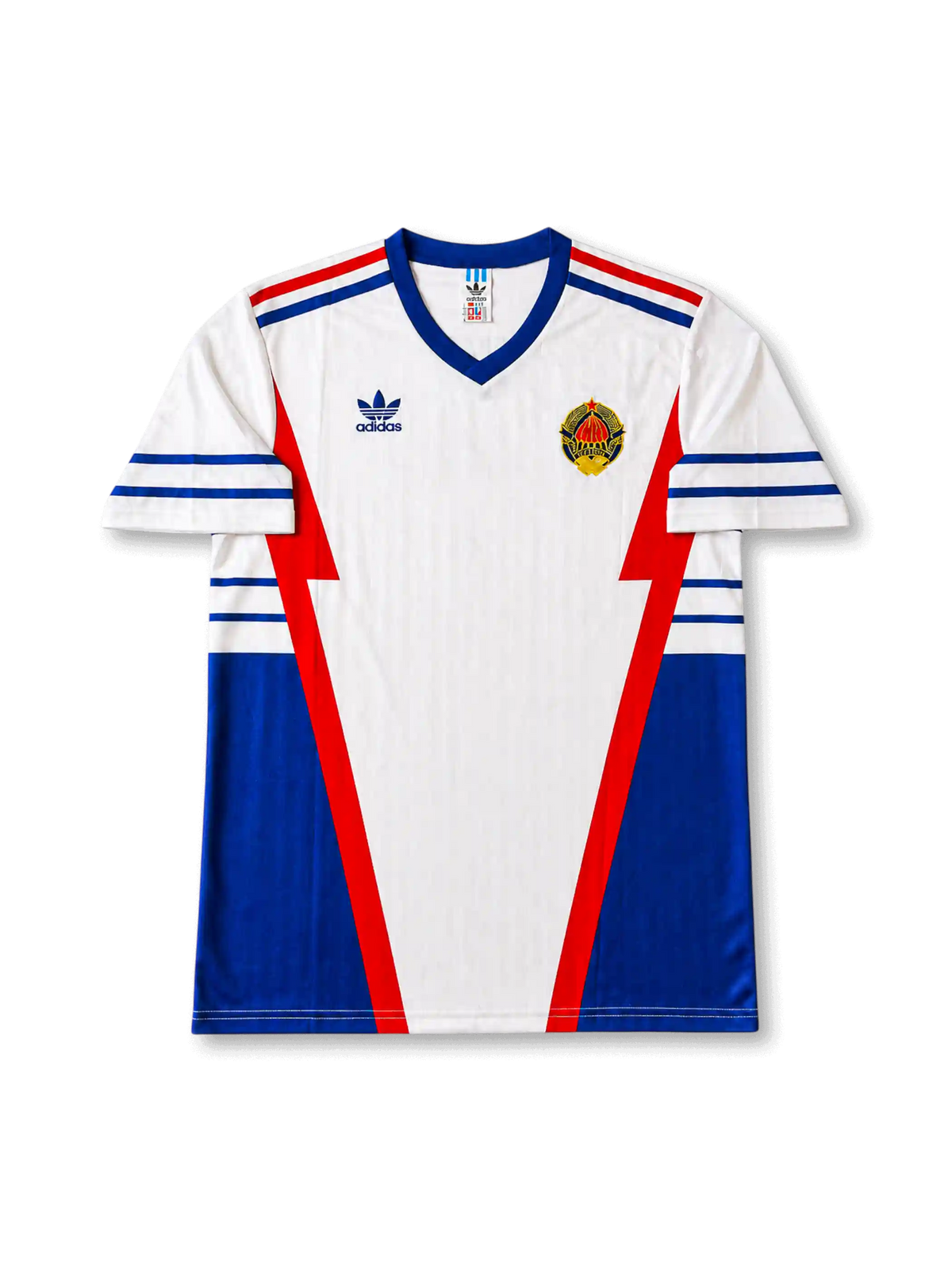 front view of Yugoslavia 1998 World Cup away shirt with white base, blue side panels, red geometric details, adidas trefoil logo, and national crest