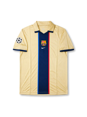 Barcelona 1999-00 away jersey front view with champagne-gold body, central navy stripe, club crest, and Champions League sleeve patch.