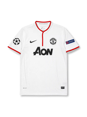 ront view of Manchester United 2012-13 away shirt with white body, red trim, Aon sponsor, club crest, Champions League patch, and UEFA Respect sleeve patch