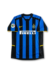 front view of Inter Milan 2002-03 home shirt with blue and black stripes, Pirelli sponsor, Inter crest, Nike logo, yellow trim, and Serie A sleeve patch