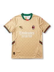 Front view of AC Milan special edition shirt in gold with monogram pattern, Emirates Fly Better sponsor, green collar, and red-green trim accents.