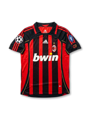 Front view of AC Milan home shirt in black and red stripes with bwin sponsor, adidas logo, club crest, gold star, and European competition sleeve patches.
