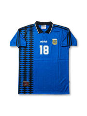 Front view of Argentina 1994-style away shirt in royal blue with black geometric side panel, AFA crest, black collar, and white number 18.