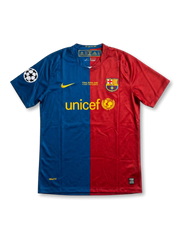Front view of Barcelona 2009 Champions League Final home shirt in split blue and red with UNICEF sponsor, Rome final embroidery, club crest, and Champions League sleeve patch.