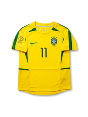 Front view of Brazil 2002 World Cup home shirt in yellow with green trim, CBF crest, Korea/Japan 2002 tournament print, and number 11 on the front.
