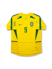 Front view of Brazil 2002 World Cup home shirt in yellow with green trim, CBF crest, Korea/Japan 2002 tournament print, and number 9 on the front.