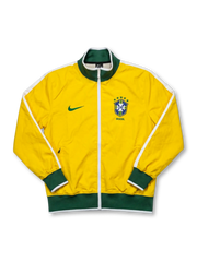 Brazil national team Nike track jacket in canary yellow with green ribbed collar and hem, white shoulder piping, green Swoosh at left chest, five-star CBF crest and BRASIL wordmark at right chest