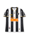Atlético Mineiro 2013 home jersey featuring Ronaldinho #10, Lupo Sport black and white vertical striped soccer shirt with gold-trimmed V-neck, orange Banco BMG sponsor logo, CAM club crest, MRV sleeve branding, and RONALDINHO name and number 10 on the back, celebrating the club's 2013 Copa Libertadores winning season.