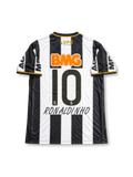 Atlético Mineiro 2013 home jersey featuring Ronaldinho #10, Lupo Sport black and white vertical striped soccer shirt with gold-trimmed V-neck, orange Banco BMG sponsor logo, CAM club crest, MRV sleeve branding, and RONALDINHO name and number 10 on the back, celebrating the club's 2013 Copa Libertadores winning season.