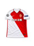 AS Monaco 2016-17 home jersey featuring Kylian Mbappe #29, Nike red and white diagonal split soccer shirt with subtle tonal horizontal graphics, white sleeves, red-trimmed V-neck collar, FEDCOM sponsor logo, AS Monaco club crest, UEFA Champions League and Respect sleeve patches, and MBAPPÉ name with number 29 on the back.