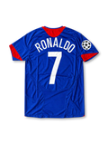 Front view of the 2005/06 Manchester United blue away soccer jersey by Nike, featuring red shoulder accents, a central club crest, white Vodafone sponsor, and UEFA Champions League sleeve patch.