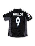 Front view of the black Real Madrid 2003/04 third soccer jersey featuring dark gray side panels, white adidas shoulder stripes, a crowned Real Madrid crest, Siemens Mobile sponsor, and La Liga LFP sleeve patch.