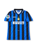 Front view of the Inter Milan 1997/98 blue and black striped home soccer jersey featuring an Umbro logo, central club crest with gold star, white Pirelli sponsor, patterned black stripes, and Lega Calcio sleeve patch.