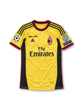 Front view of the AC Milan 2013-14 gold third football jersey featuring Kaká #22, black adidas shoulder stripes and side panels, red trim, Fly Emirates sponsor, Italian flag chest detail, and UEFA Champions League sleeve patches.