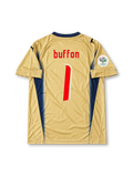 Gold Puma Italy 2006 World Cup goalkeeper away jersey associated with Gianluigi Buffon #1, featuring navy blue V-neck trim, Italian national team crest, Puma logos, and Germany 2006 World Cup sleeve patch.