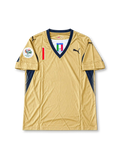 Gold Puma Italy 2006 World Cup goalkeeper away jersey associated with Gianluigi Buffon #1, featuring navy blue V-neck trim, Italian national team crest, Puma logos, and Germany 2006 World Cup sleeve patch.