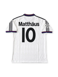 Front view of the Bayern Munich 1996-98 adidas away soccer jersey in white with vertical blue and red stripes, black polo collar, adidas Three Stripes, Opel chest sponsor, club crest, and UEFA Champions League sleeve patch.