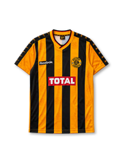 Kaizer Chiefs 1998-99 home jersey, front view, gold and black vertical stripe pattern, V-neck collar with red trim, Reebok logo, Kaizer Chiefs crest with chief-head emblem, red TOTAL sponsor logo, black shoulder panels with gold arrow trim