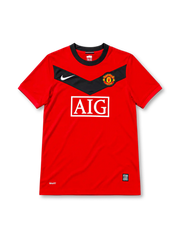 Manchester United 2009/10 red home jersey featuring a black chest chevron, white Nike logo, AIG sponsor, and club crest, front view.
