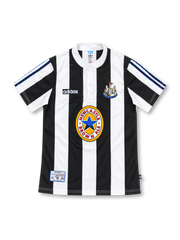 Newcastle United 1995/97 black-and-white striped home jersey with adidas logo, buttoned white collar, club crest, and Newcastle Brown Ale sponsor, front view.