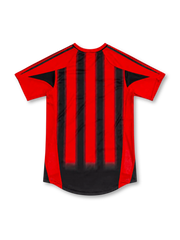 AC Milan 2004/05 home jersey with red-and-black vertical stripes, adidas logo, Opel sponsor, club crest, and gold star, front view.