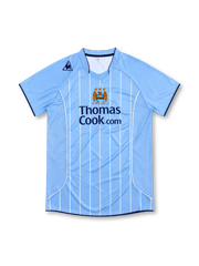 Manchester City 2007/08 sky-blue home jersey with white pinstripes, Le Coq Sportif logo, central club crest and Thomas Cook.com sponsor.