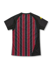 Manchester City 2008/09 black away jersey with marbled red stripes, white Thomas Cook.com sponsor, yellow Le Coq Sportif logo and club crest.