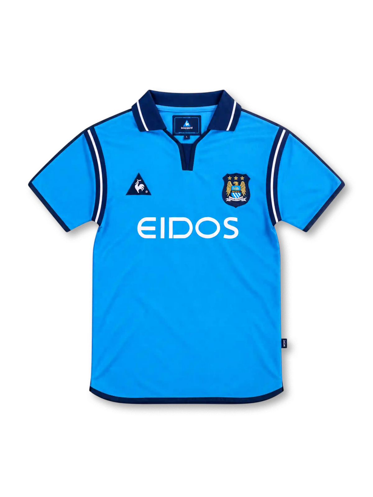 Manchester City 2001/02 sky-blue home jersey with navy polo collar, white EIDOS sponsor, Le Coq Sportif logo and three-star club crest.