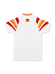 Spain 1996 white third jersey by adidas with sweeping red-and-yellow shoulder stripes, matching striped V-neck collar, red adidas wordmark, central Spanish federation crest and decorative hem patch.