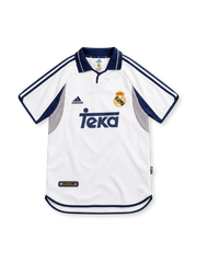 Real Madrid 2000/01 white adidas home jersey featuring navy polo collar, navy shoulder stripes, grey and navy curved side panels, crowned club crest, navy Teka sponsor and curved hem.