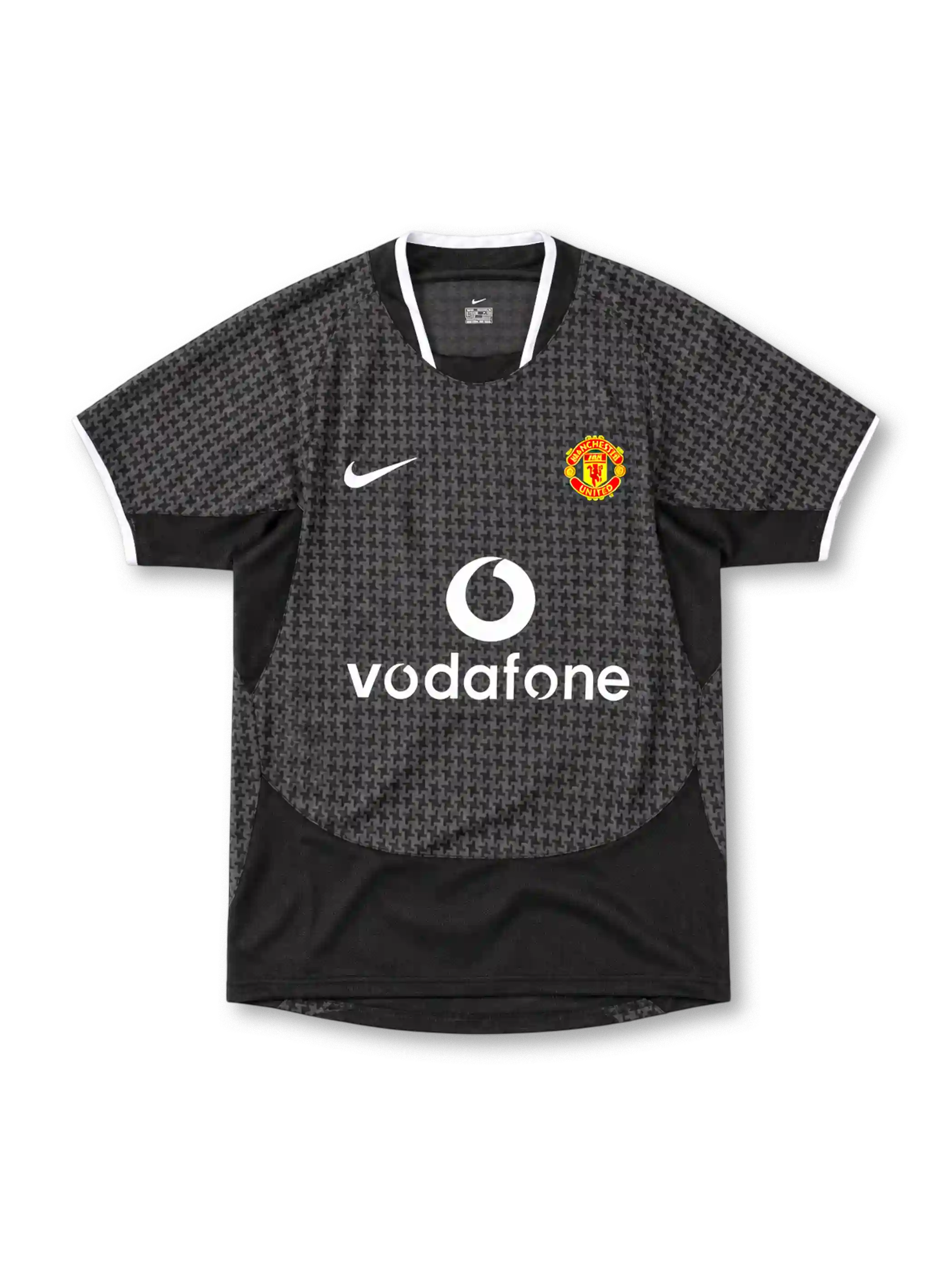 Manchester United 2003/05 Nike away jersey in black and charcoal grey with an all-over geometric pattern, white-trimmed collar and sleeve cuffs, white Nike Swoosh, Manchester United crest and Vodafone sponsor.